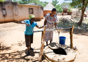 Faith Chasakara, who suffers from blinding trachoma, at the community well that provides clean water in Bindura, Zimbabwe.