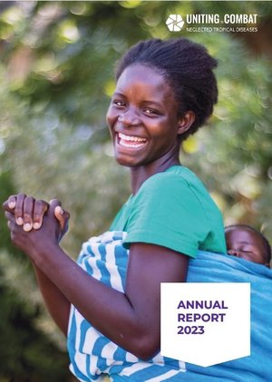 A woman smiles to camera with her hands clasped and a baby on her back, on the cover of the 2023 Uniting annual report