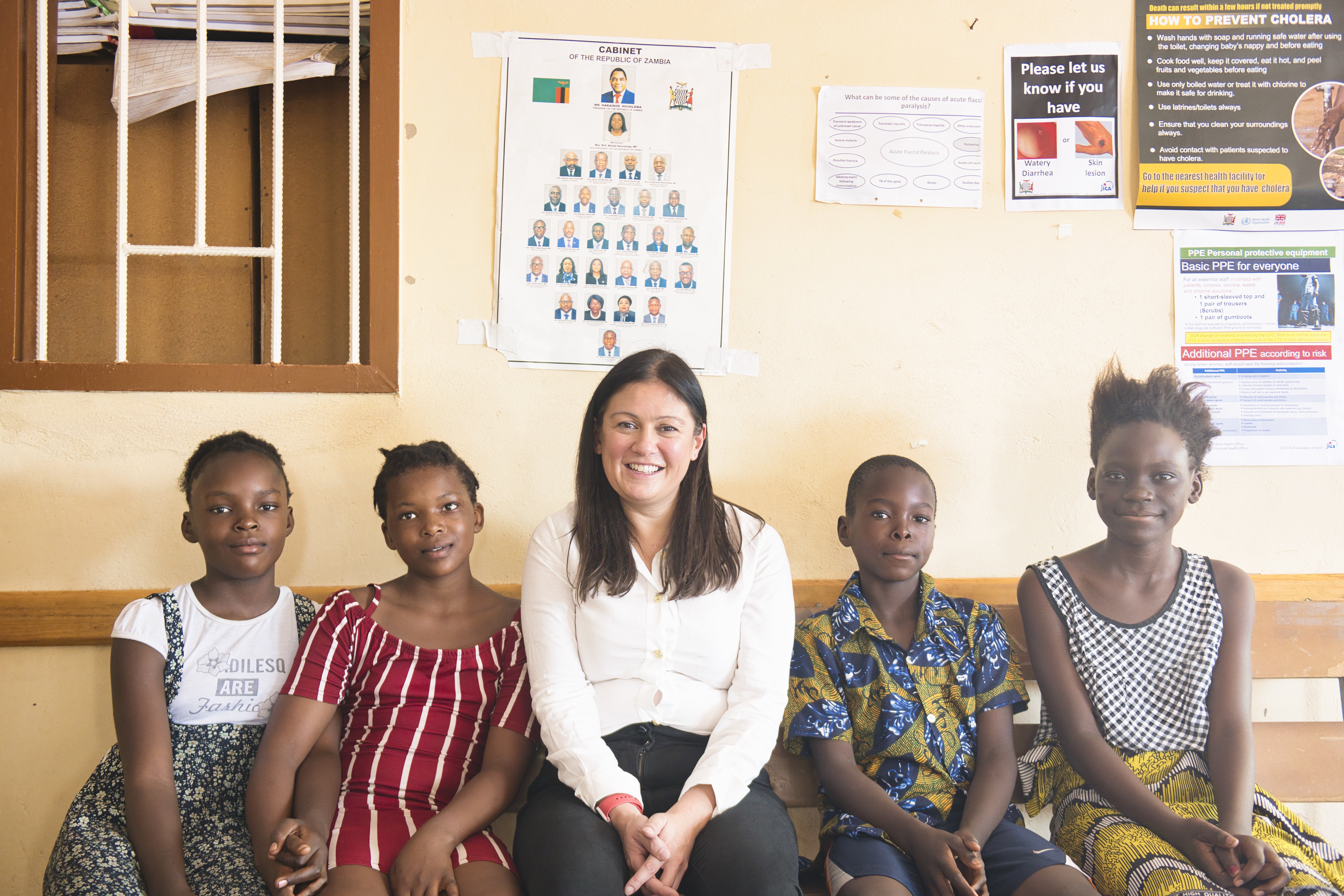 Lisa Nandy MP sits with children Mama, Masiha, Rachel and Rajab at the Shikoswe Health District Hospital