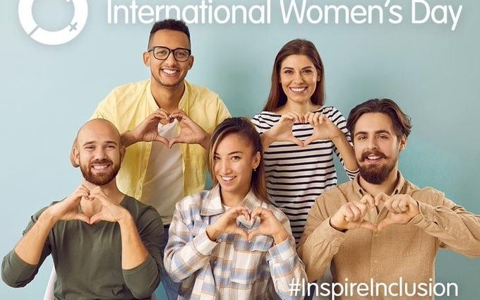 Five individuals show the International Women's Day heart
