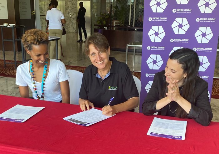Three representatives from the NALA Foundation sign the Kigali Declaration on NTDs