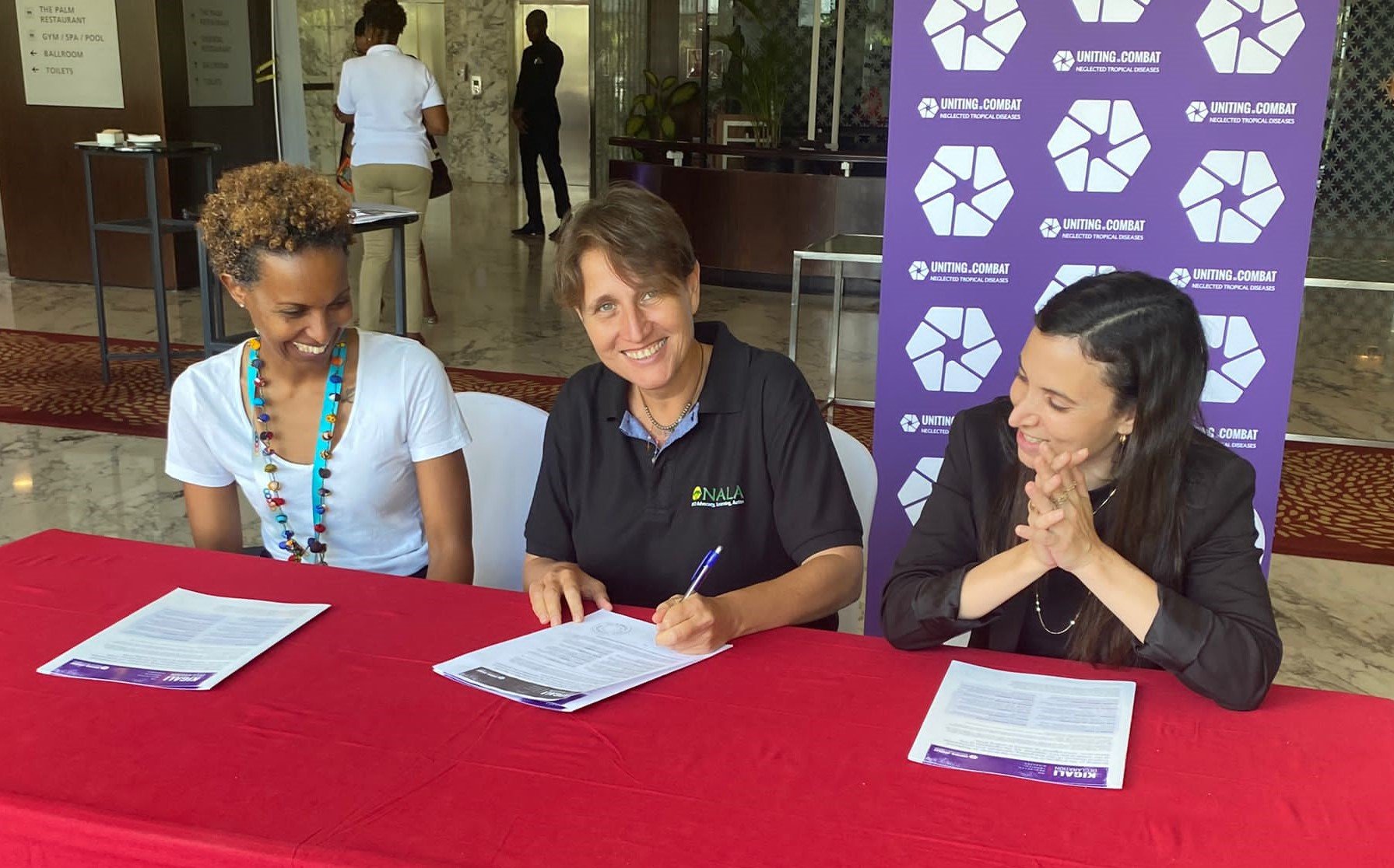 Three representatives from the NALA Foundation sign the Kigali Declaration on NTDs