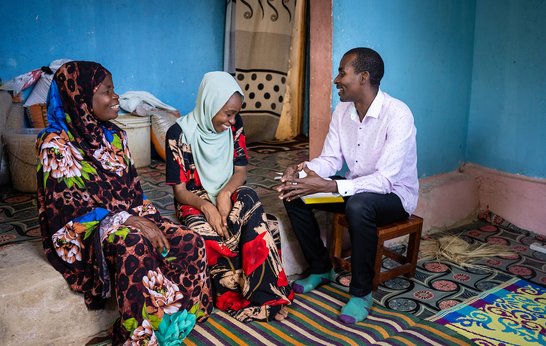 Mr Seif Bakar Shaibu (pictured right) meets with Mzowele Khamisi Juma, a 52-year-old LF patient (pictured left) and her daughter Zuleika Sheha Haji, who serves as her primary caregiver (center)