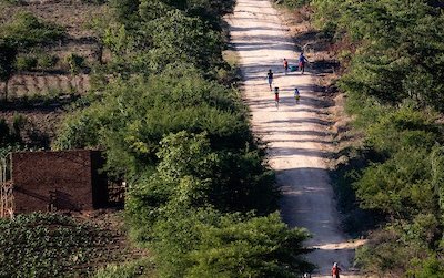 Zimbabwe Road in the afternoon, a few people walking along in the sunshine.