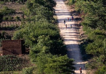 Zimbabwe Road in the afternoon, a few people walking along in the sunshine.